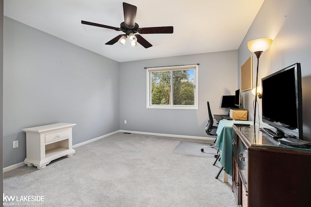 carpeted office space with ceiling fan