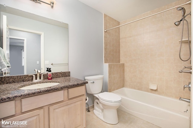 full bathroom featuring tile patterned flooring, vanity, toilet, and tiled shower / bath