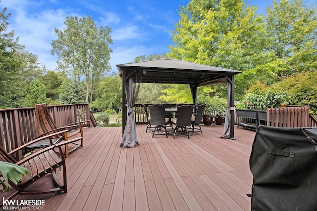 wooden deck featuring a gazebo and area for grilling