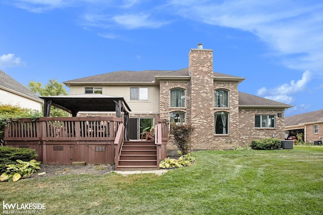 back of house featuring a lawn, a wooden deck, a gazebo, and central AC unit