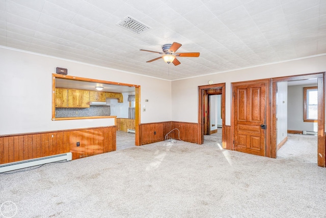 unfurnished room featuring ceiling fan, light colored carpet, and a baseboard heating unit