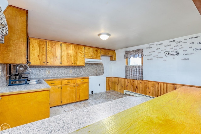 kitchen featuring light tile patterned floors, a baseboard heating unit, and sink