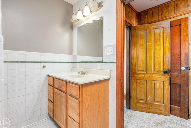 bathroom with vanity and tile walls