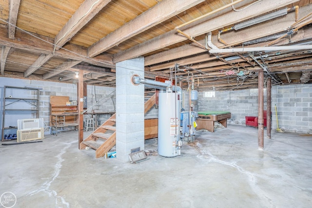 basement featuring an AC wall unit and gas water heater