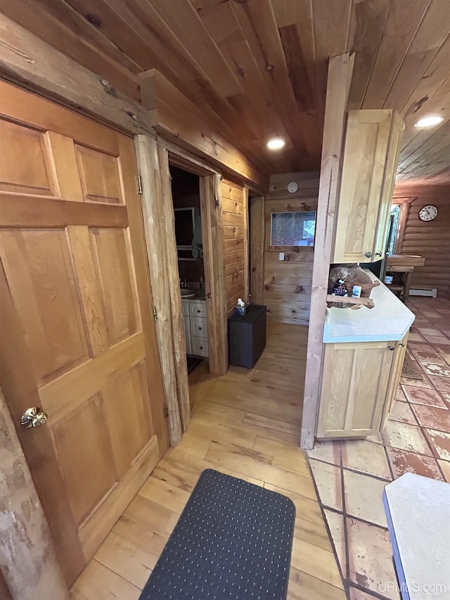 interior space featuring vanity, wooden walls, log walls, hardwood / wood-style flooring, and wooden ceiling