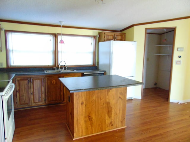 kitchen with a center island, dark hardwood / wood-style floors, white appliances, and sink