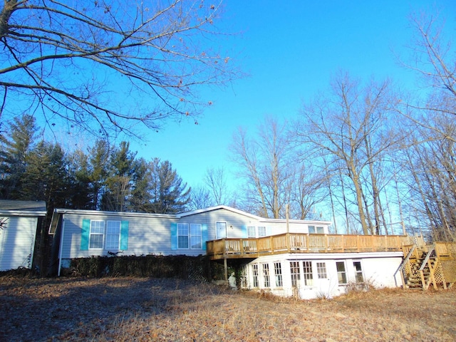 rear view of property featuring a deck