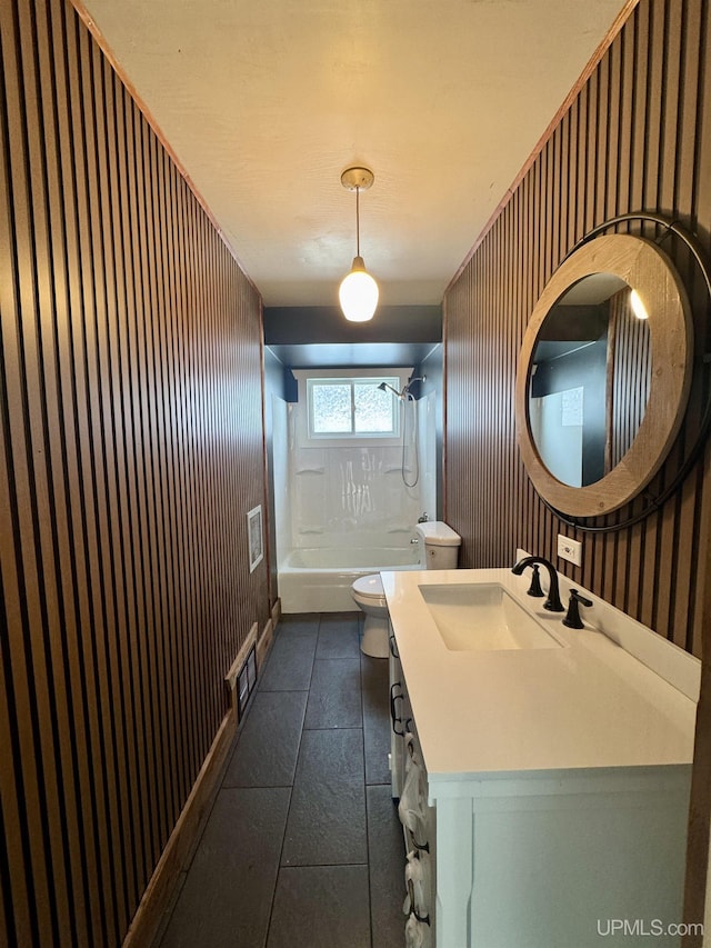 full bathroom featuring toilet, tile patterned flooring, shower / tub combination, vanity, and wood walls