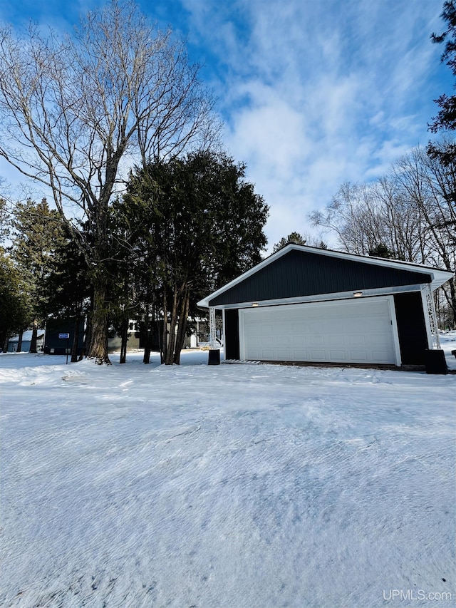 view of front of home with a garage and an outdoor structure