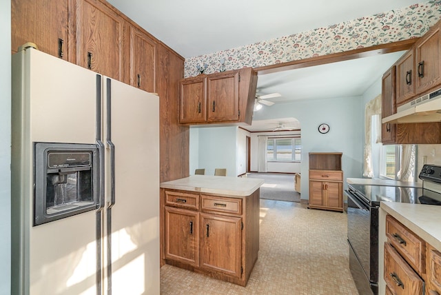 kitchen featuring white refrigerator with ice dispenser, electric range, ceiling fan, kitchen peninsula, and extractor fan