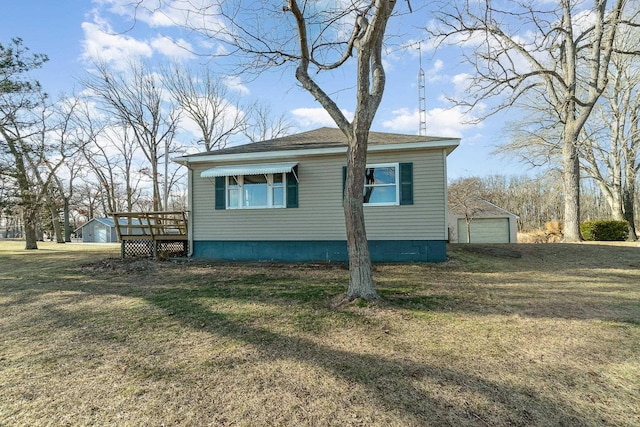 view of side of property with a yard, a deck, a garage, and an outdoor structure