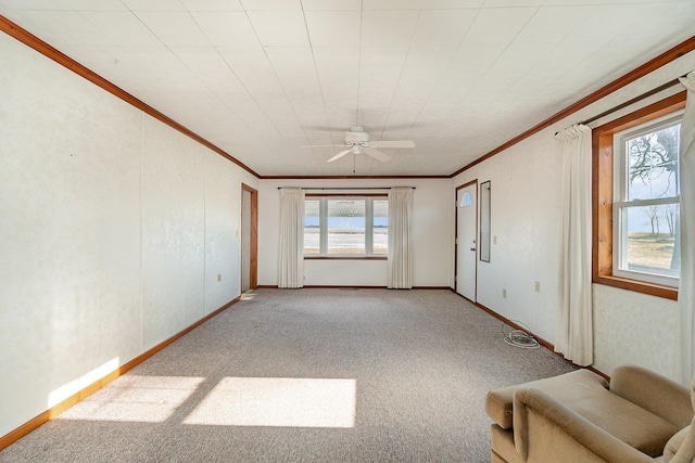 unfurnished living room with ceiling fan, light colored carpet, and ornamental molding