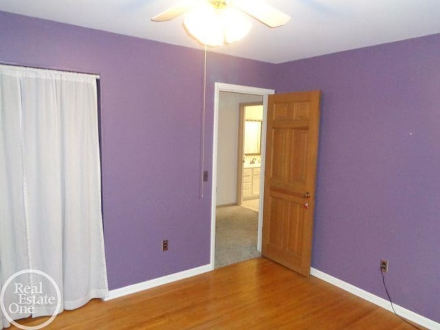 unfurnished bedroom featuring ceiling fan and wood-type flooring