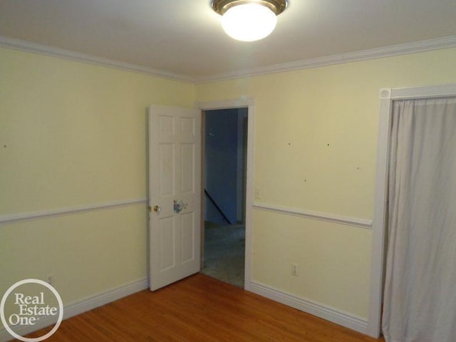 interior space featuring hardwood / wood-style flooring and ornamental molding