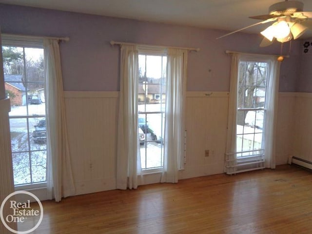 doorway to outside featuring wood-type flooring and ceiling fan