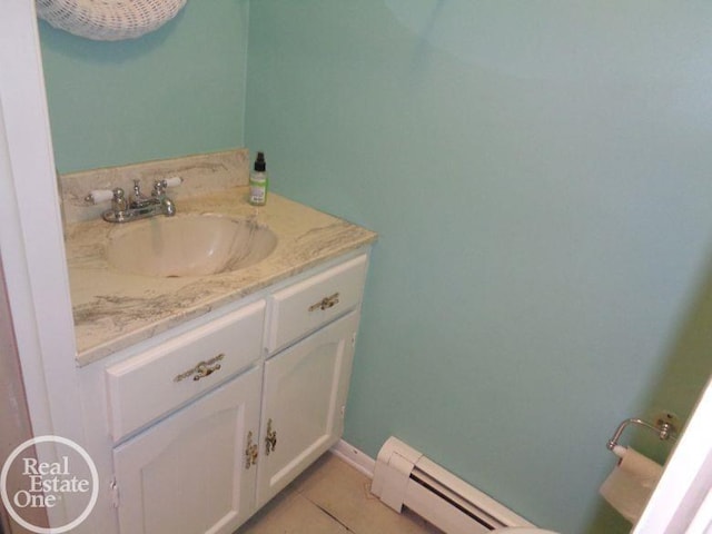 bathroom with tile patterned flooring, vanity, and a baseboard heating unit