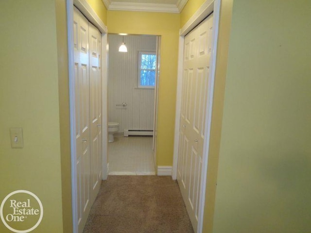 hall featuring carpet flooring, ornamental molding, and a baseboard heating unit