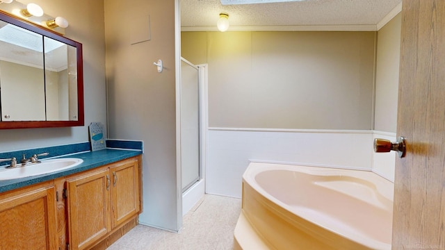 bathroom featuring plus walk in shower, a textured ceiling, vanity, and a skylight