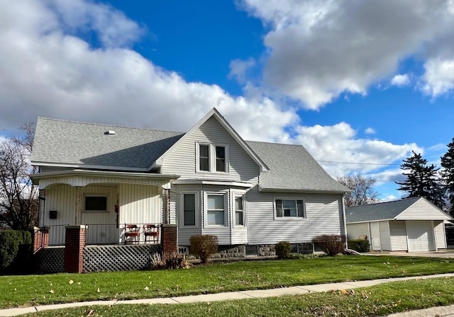 view of front of property with covered porch and a front yard