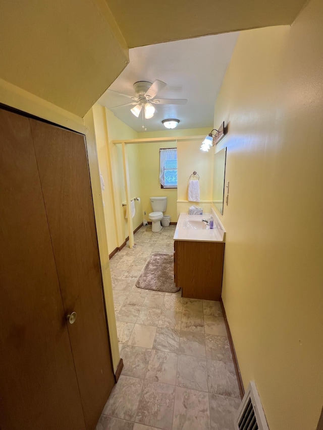 bathroom with vanity, toilet, and ceiling fan