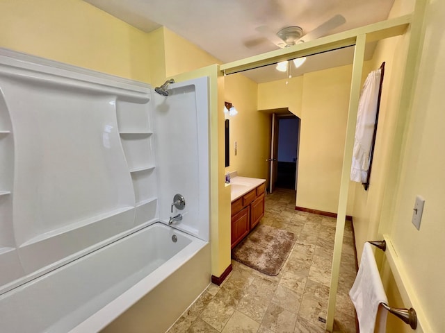 bathroom featuring vanity, ceiling fan, and washtub / shower combination