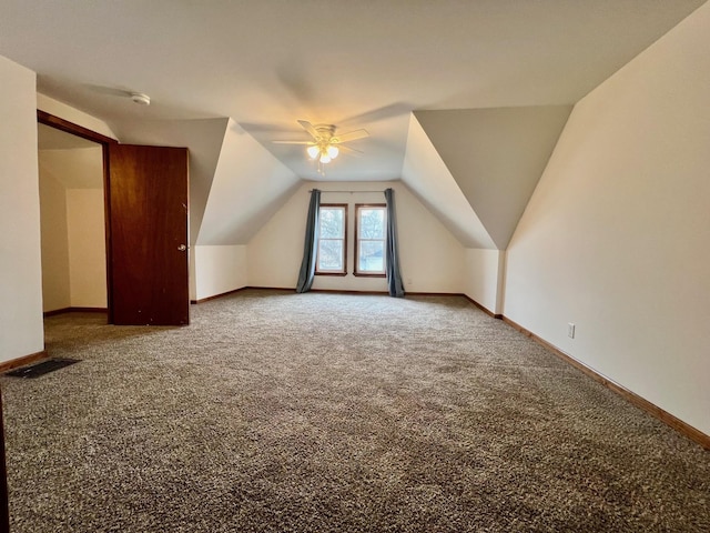 additional living space with carpet flooring, ceiling fan, and lofted ceiling