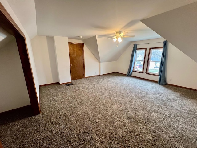 additional living space featuring carpet flooring, ceiling fan, and lofted ceiling