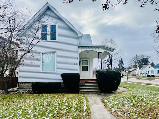 view of front of property with a front yard and covered porch