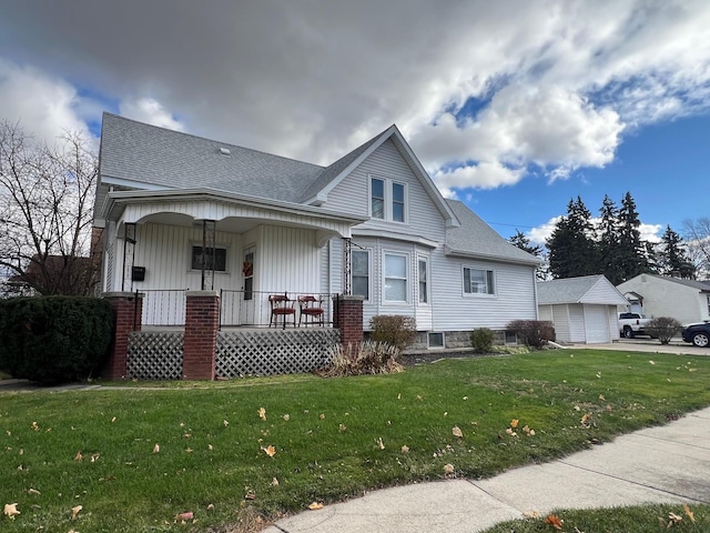 view of front of property with a front lawn, covered porch, and an outdoor structure