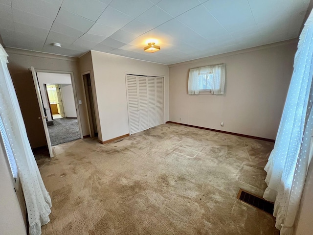 unfurnished bedroom with a closet and carpet floors