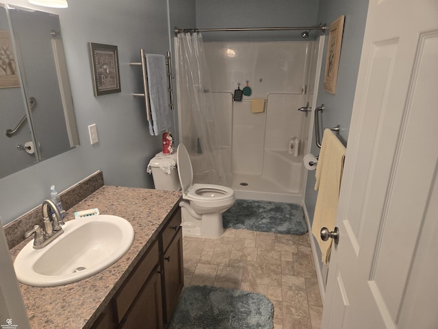 bathroom with vanity, toilet, and curtained shower