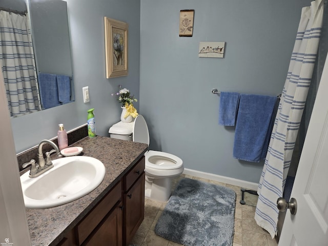 bathroom featuring tile patterned floors, vanity, and toilet