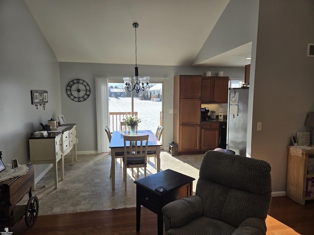 dining room with a notable chandelier, lofted ceiling, and dark wood-type flooring