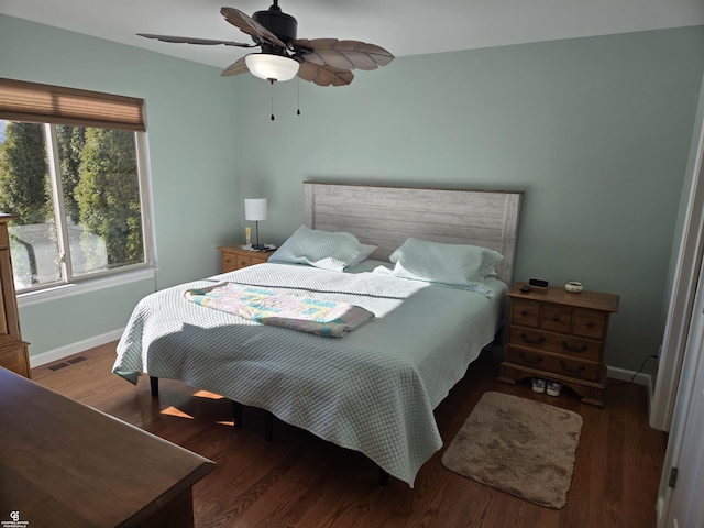 bedroom with ceiling fan and dark hardwood / wood-style floors