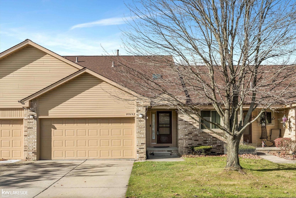 view of front of house featuring a garage and a front lawn