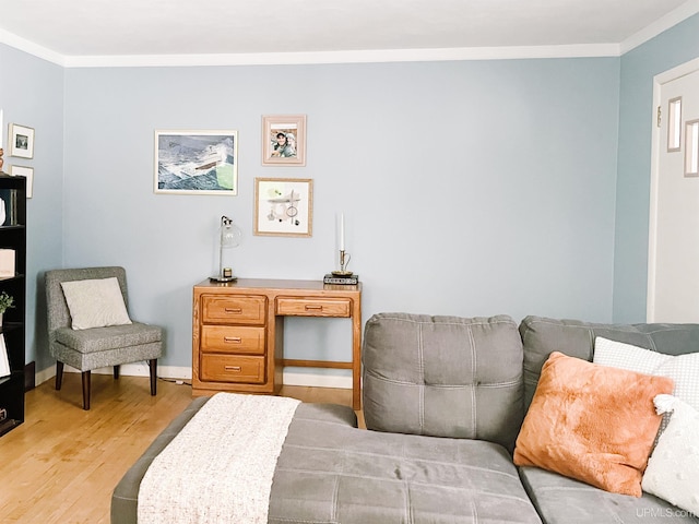 sitting room with light hardwood / wood-style floors and crown molding