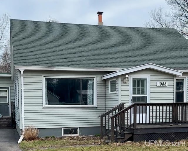 rear view of house with a wooden deck