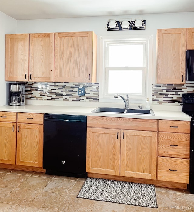 kitchen with light brown cabinetry, sink, tasteful backsplash, and black appliances