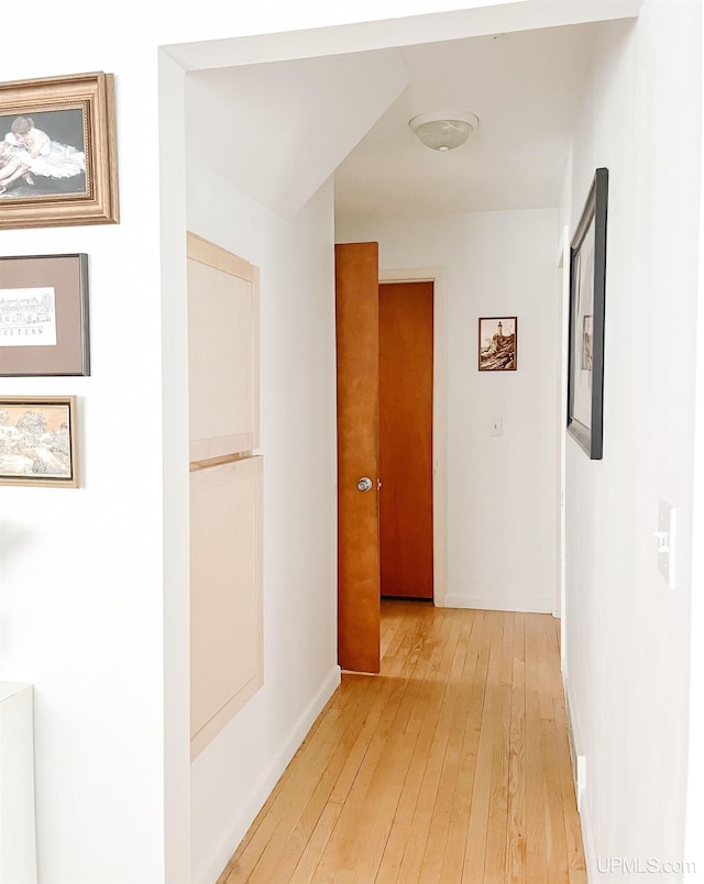 hallway with light hardwood / wood-style flooring