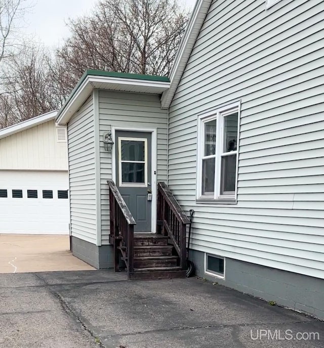 view of exterior entry featuring a garage