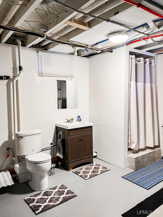 bathroom with vanity, concrete floors, and toilet