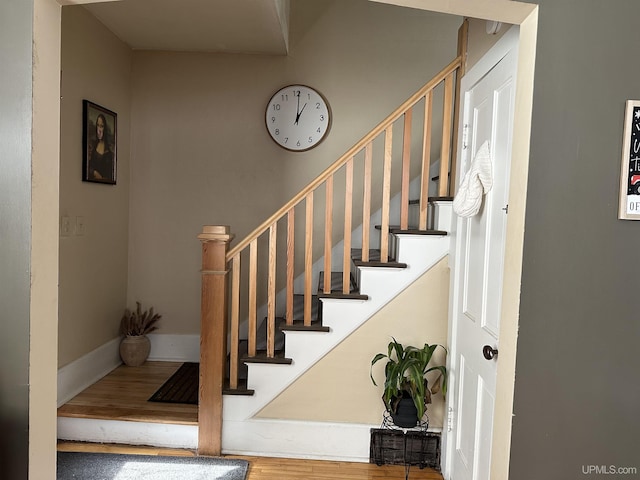 stairway with hardwood / wood-style flooring