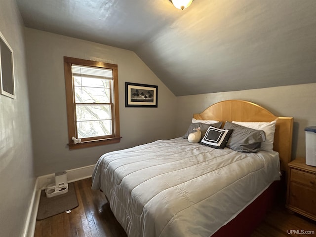 bedroom featuring dark wood-type flooring and vaulted ceiling