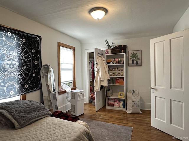 bedroom with dark hardwood / wood-style floors