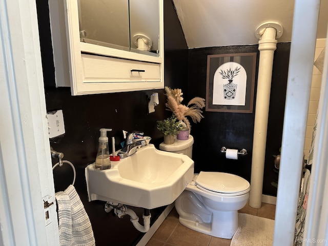 bathroom featuring sink, tile patterned flooring, and toilet