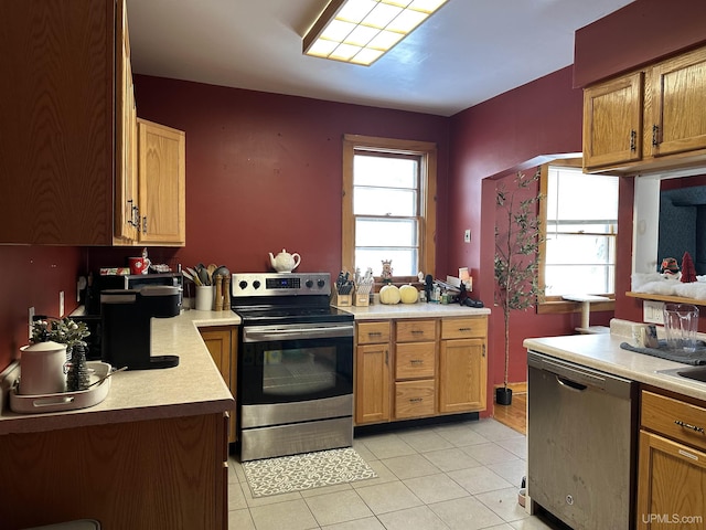 kitchen with stainless steel appliances and light tile patterned flooring