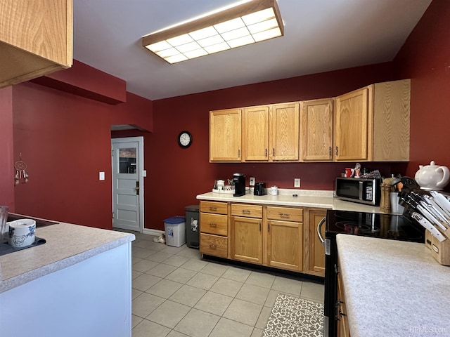 kitchen with light tile patterned floors and electric stove