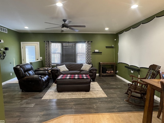 living room with crown molding, ceiling fan, and dark wood-type flooring