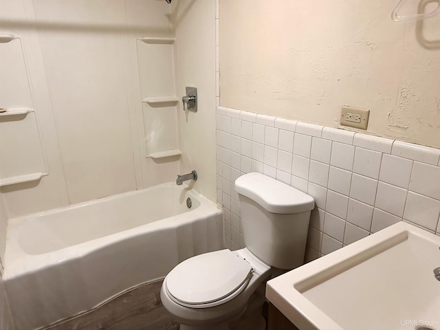 full bathroom with tile walls, toilet, shower / bathtub combination, and sink