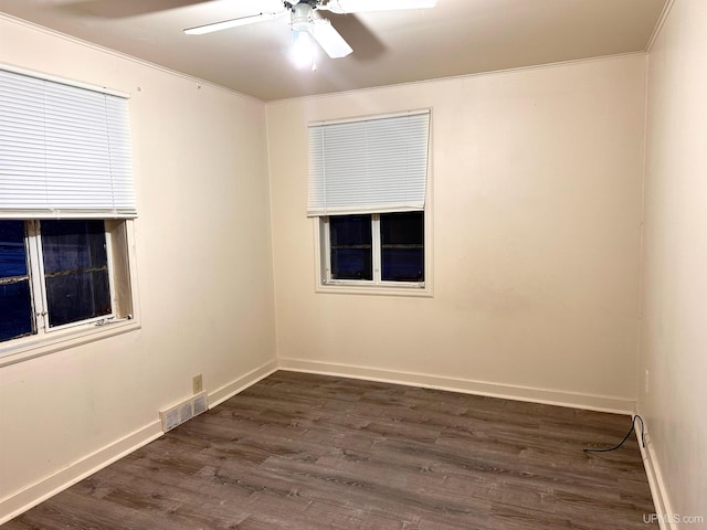 spare room with ceiling fan and dark wood-type flooring